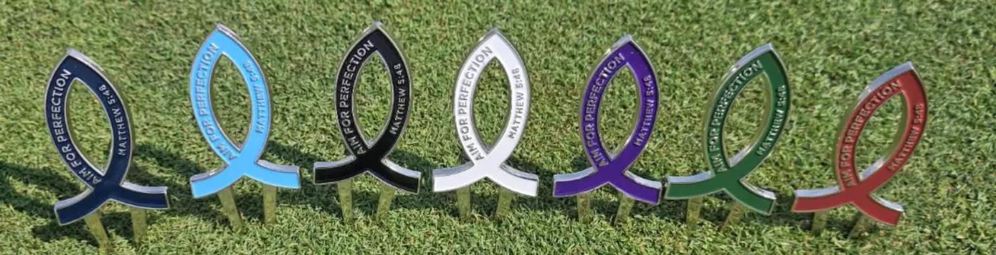 All seven Aim for Perfection divot tool colorways standing side by side on the green
