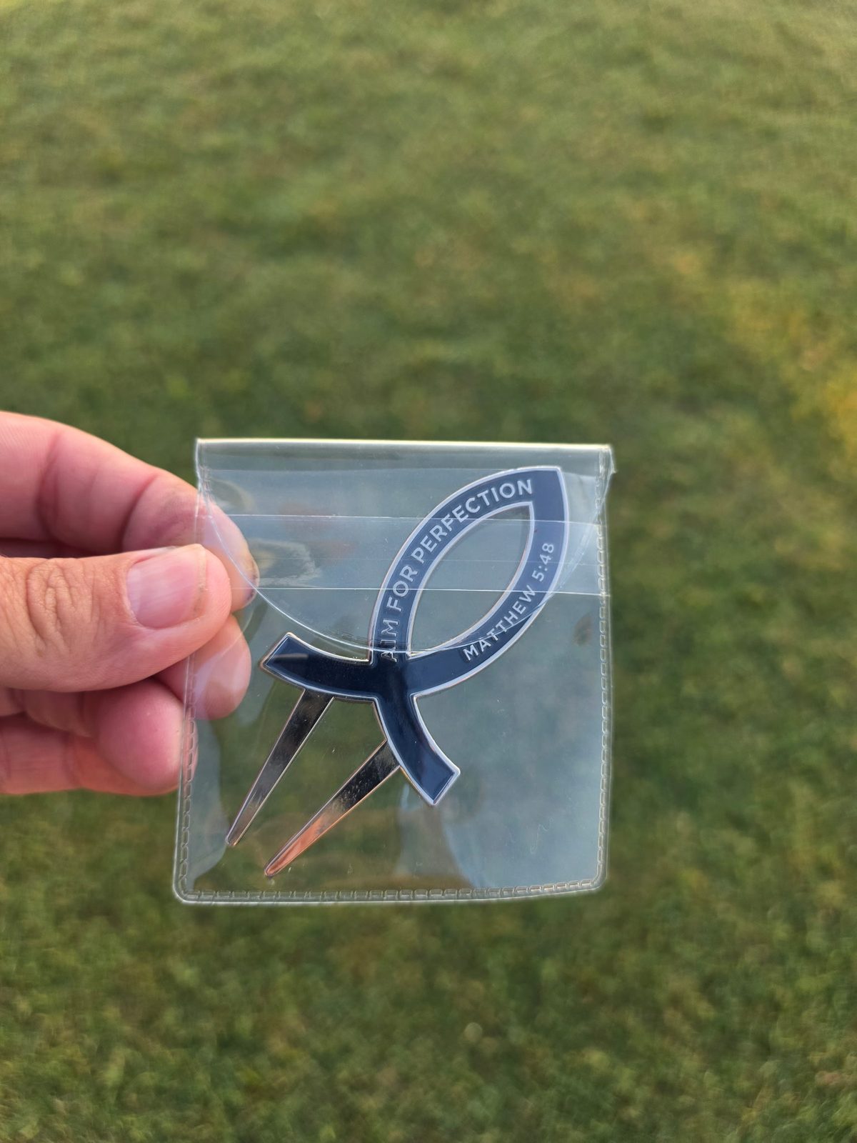 Signature Ichthys Divot Tool in its clear carry pouch